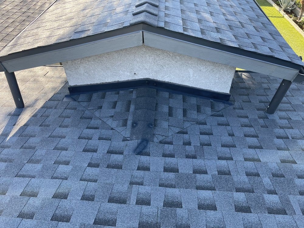 Close-up view of damaged roof shingles on a residential home.