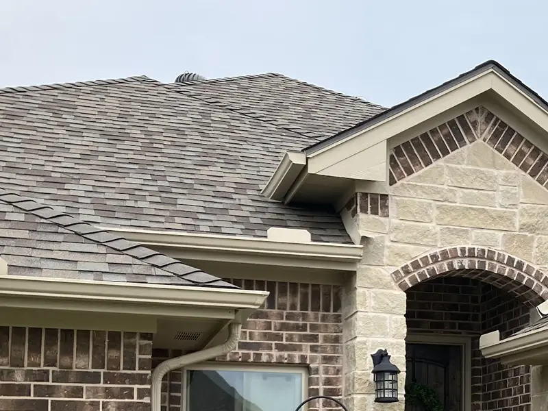 Roofer inspecting a residential roof